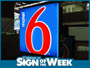 Sign of the Week for Motel 6 with White and Red Lettering on a Blue Background - Home Page